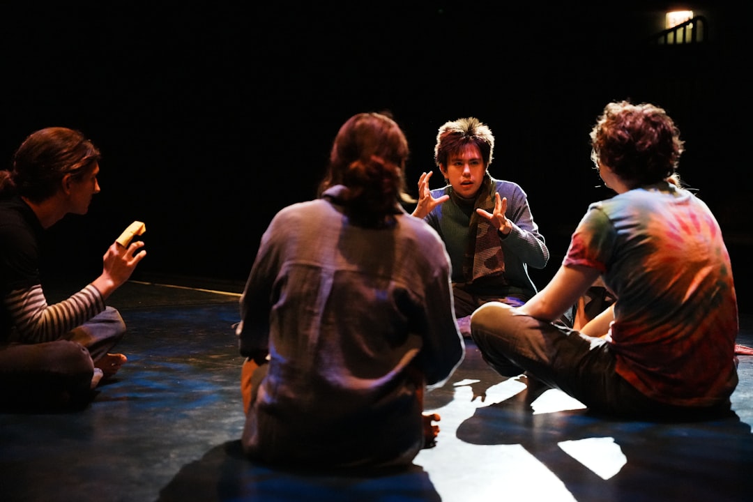A group of people sitting on the floor talking